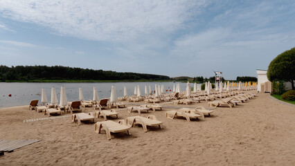 empty sandy beach with sunbeds and umbrellas