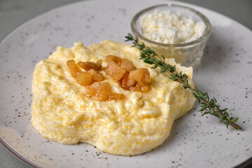 Delicious polenta with crispy pork cracklings and fresh herbs.