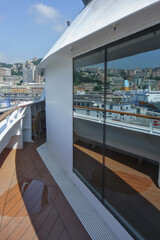 Outdoor sun pool promenade deck with chairs or sun loungers with table on balcony or terrace or...