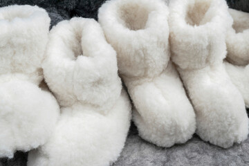 white woolen warm winter socks at a Christmas market, selective focus. soft, fluffy, cozy fur autumn background 