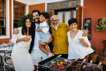 Family enjoying a Brazilian churrasco gathering in their backyard