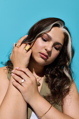 Obraz premium Stylish woman showcasing beauty with Waardenburg syndrome against a vibrant blue backdrop