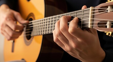 Fototapeta premium Close-up of acoustic guitar being played showing someone strumming strings. Acoustic guitar performance includes fingers pressing chords on fretboard, resulting in beautiful music.
