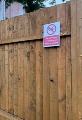 No Smoking and Vaping Sign on a Wooden Fence Outdoors
