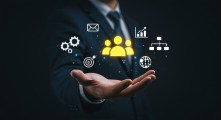 A businessman in a suit holds out his hand, presenting a team icon and other businessrelated icons, symbolizing teamwork, collaboration, and business strategy