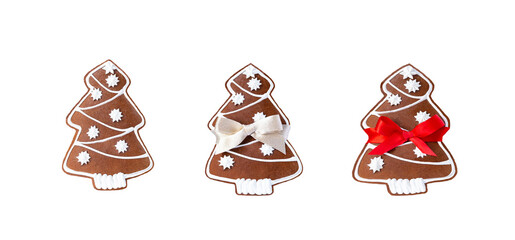 Set of tasty ginger and honey Christmas trees shaped cookie with white icing. Two cookies tied golden and red ribbon. Isolated on white background. Christmas, New Year, party,, holiday concept.