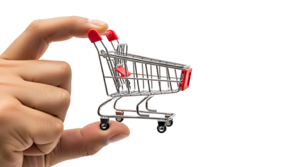 A miniature shopping cart is held by a hand against a black background.