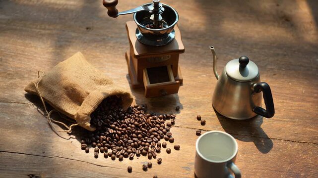 The Way of Coffee: A wooden table with a coffee grinder, fresh coffee beans, coffee cups and a kettle, under warm natural light.