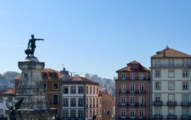 Obraz premium Historic architecture and monument in Porto, Portugal. Old town facades with balconies and statue on