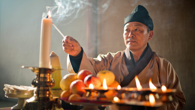 Korean ancestral rite, Chuseok ceremony, traditional memorial ritual, lighting candle, cultural heritage, offering table, autumn tribute