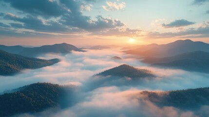 Beautiful sunrise over misty mountain range with clouds and rolling hills, peaceful natural landscape during early morning, scenic view of sunrise in nature, tranquil atmosphere