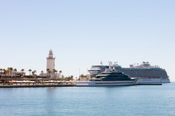 Malaga, Andalusia, Spain. 4 September 2025. Lighthouse and cruise ships at port