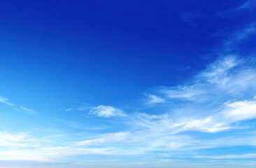 Expansive blue sky filled with soft, wispy cirrus clouds. The gradient shifts to a pale horizon, creating a sense of depth and peacefulness