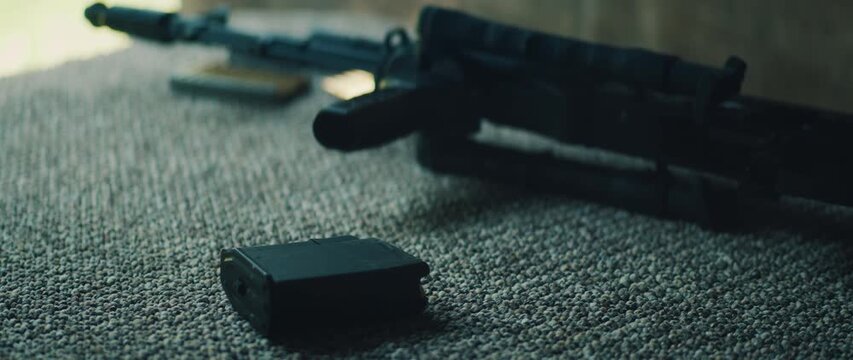 Rifle and magazine placed on carpeted bench in shooting range environment