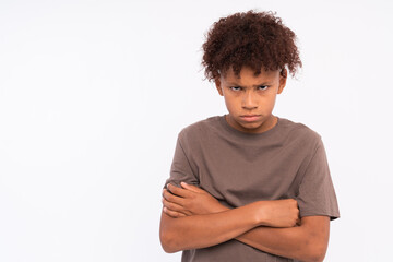 Isolated image of emotional Afro American schoolboy frowning brows and opening eyes wide expressing displeasure, bewilderment, having perplexed look. Human facial expressions, feelings and reaction