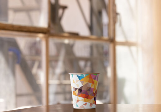 Mockup of Take away paper Cup on Table by Window