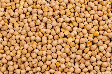 Close-up of dried chickpeas forming a textured background.