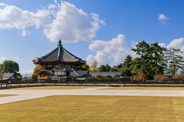The Southern Round Hall of Kofuku-ji in Nara, Japan, stands under blue sky with scattered clouds,...