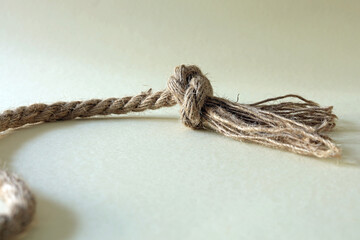 knot on a rope with frayed end.