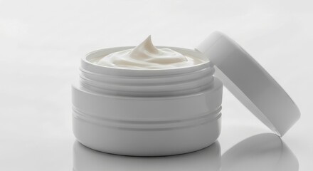 White cosmetic cream jar with open lid on white background studio shot