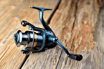 Fishing reel lies on old wooden background rustic background blank for creativity