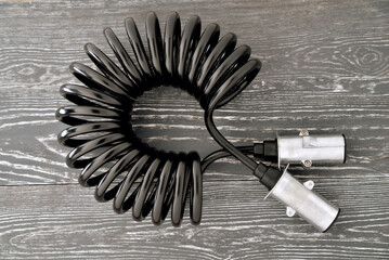 electrical Twisted cable with connectors for truck Cable for connecting a tractor to a trailer on a gray background