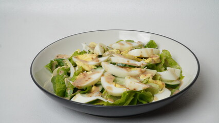 A serving of salad consisting of sliced ​​romaine lettuce, Japanese cucumber (kyuri), and...