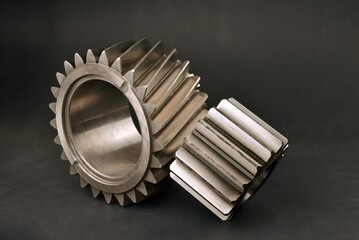 gears of gearbox and mechanisms with helical and straight teeth on black background