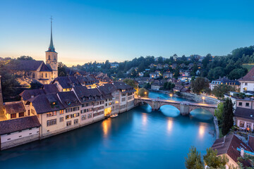 Bern, Switzerland. View of stone arch Untertorbrucke (Lower Gate Bridge) and Aare river at dusk