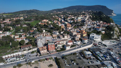 Numana aerial panorama showcasing coastal town charm and vibrant Mediterranean life overlooking Adriatic Sea and Conero Park with boats in harbor