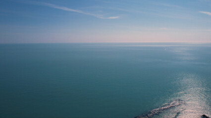 Fototapeta premium Aerial View of the Azure Adriatic Sea with the Coastline of Numana Le Marche Italy and Its Majestic Landmarks Bathed in Sunlight on a Clear Day