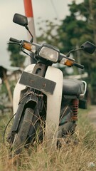 Front View of Retro Vintage Japanese Cub Motorcycle in Countryside View with Classic Warm Tone Photo