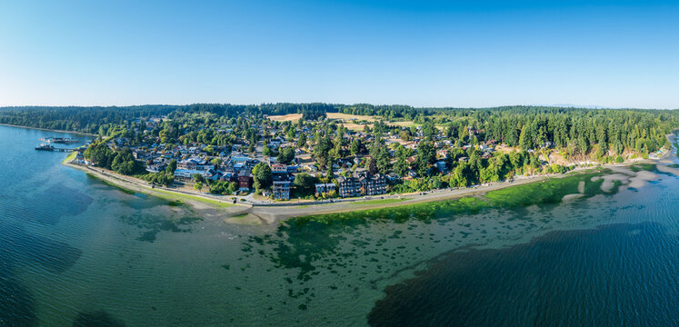 Breathtaking aerial view of resort town of Langley on Whidbey Island, Washington with clear skies and calm waters