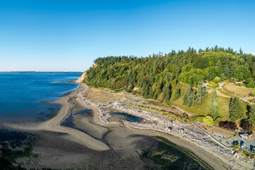 Breathtaking aerial view of Double Bluff park along Whidbey Island, Washington with clear skies and calm waters