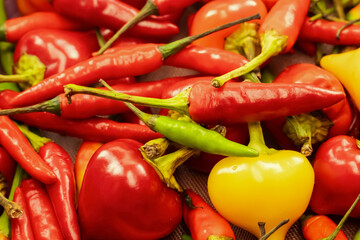 red peppers and yellow peppers are piled on top of each other