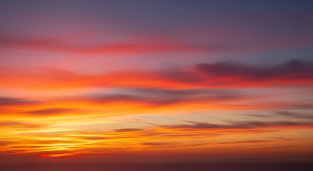 Obraz premium Vibrant Sunset Sky with Fiery Hues and Clouds.