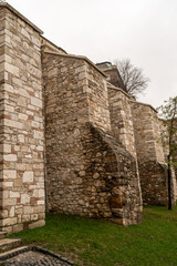 A row of stone buildings with a grassy area in between