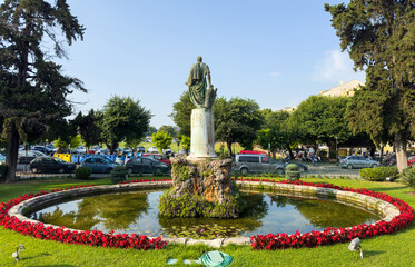 Statue and fountain surrounded by flowers in front of the Palace of St. Michael and St. George upon Corfu Island