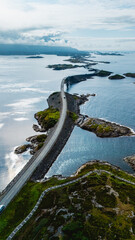 Obraz premium A breathtaking aerial view of the Atlantic Ocean Road in Norway, showcasing its unique design as it gracefully curves over water and connects islands.