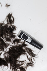 White Background with Short Dark Hair Clippings 