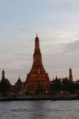 Fototapeta premium Bangkok, Thailand — City Skyline, Chao Phraya River & Temple Spires at Sunset 