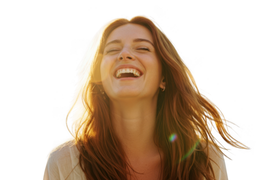 Joyful young woman with flowing auburn hair laughing with eyes closed and sunlight glinting transparent background