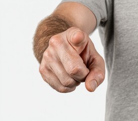 Fototapeta premium A close-up shows a person's hand with their index finger extended forward, against a stark white background, with a gray shirt sleeve visible