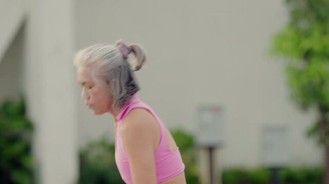 Early morning yoga group stretching into forward fold pose, cultivating flexibility, mental clarity and spine decompression outdoors.