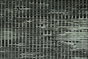 Old damaged gray metal ventilation grille background.