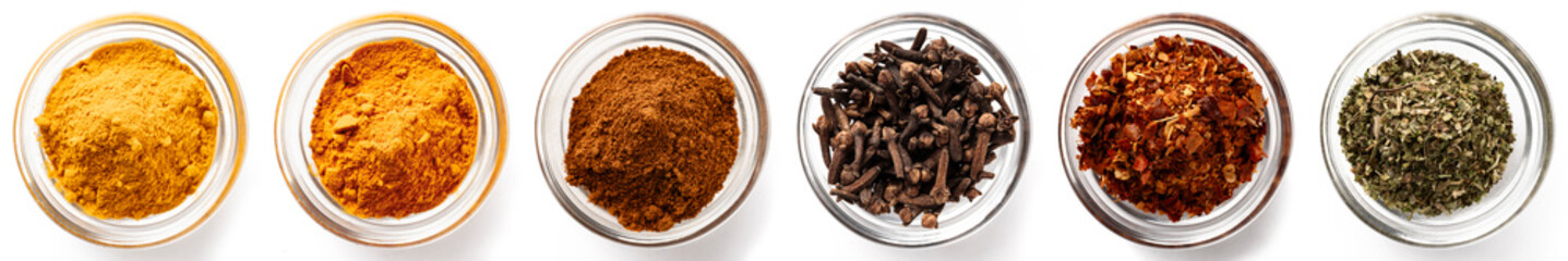 Collection of various colorful culinary spices in bowls, top view, isolated on white background