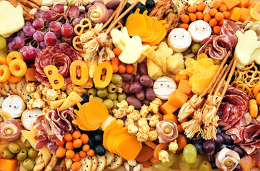 Halloween charcuterie board fun food mix: ghosts, mummies, pumpkins, eyes, brooms. Party spooky salty snacks