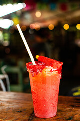 Refreshing mexican drink with chili powder and tamarind candy celebrating traditional september festivities in Mexico