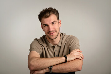 Studio portrait of a handsome young man sitting against isolated background