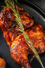 Close-up of grilled barbecue chicken with rosemary